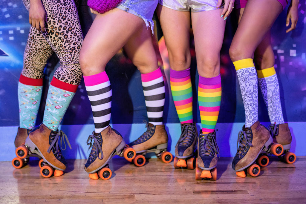 fun colorful compression socks worn in a roller skating rink