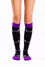 Black knee-high socks with purple cuffs, toes and heels, featuring white cat eyes with purple pupils, purple stars, and black-and-white stripes along the feet.