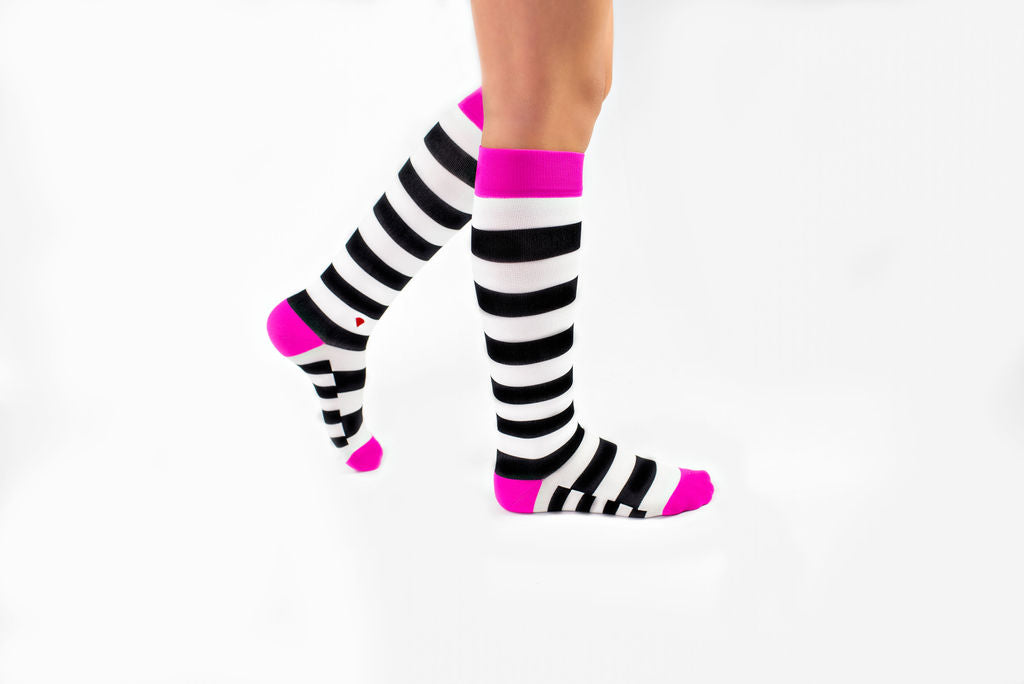 compression socks with black and white stripes and hot pink accents
