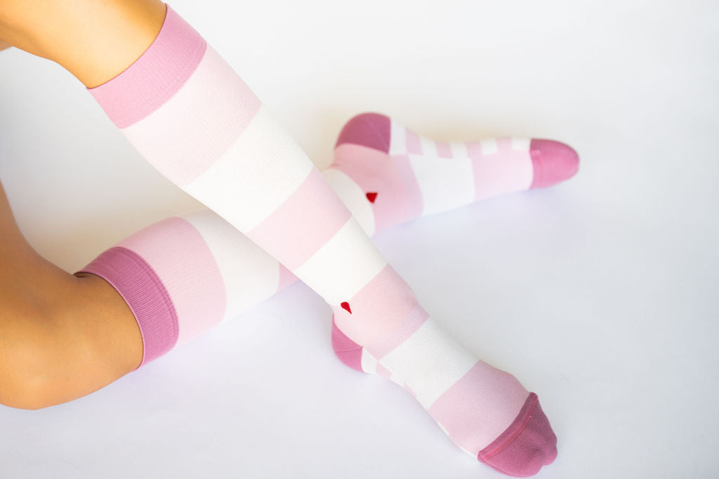 compression socks with blush and mauve stripes with darker blush/mauve accents