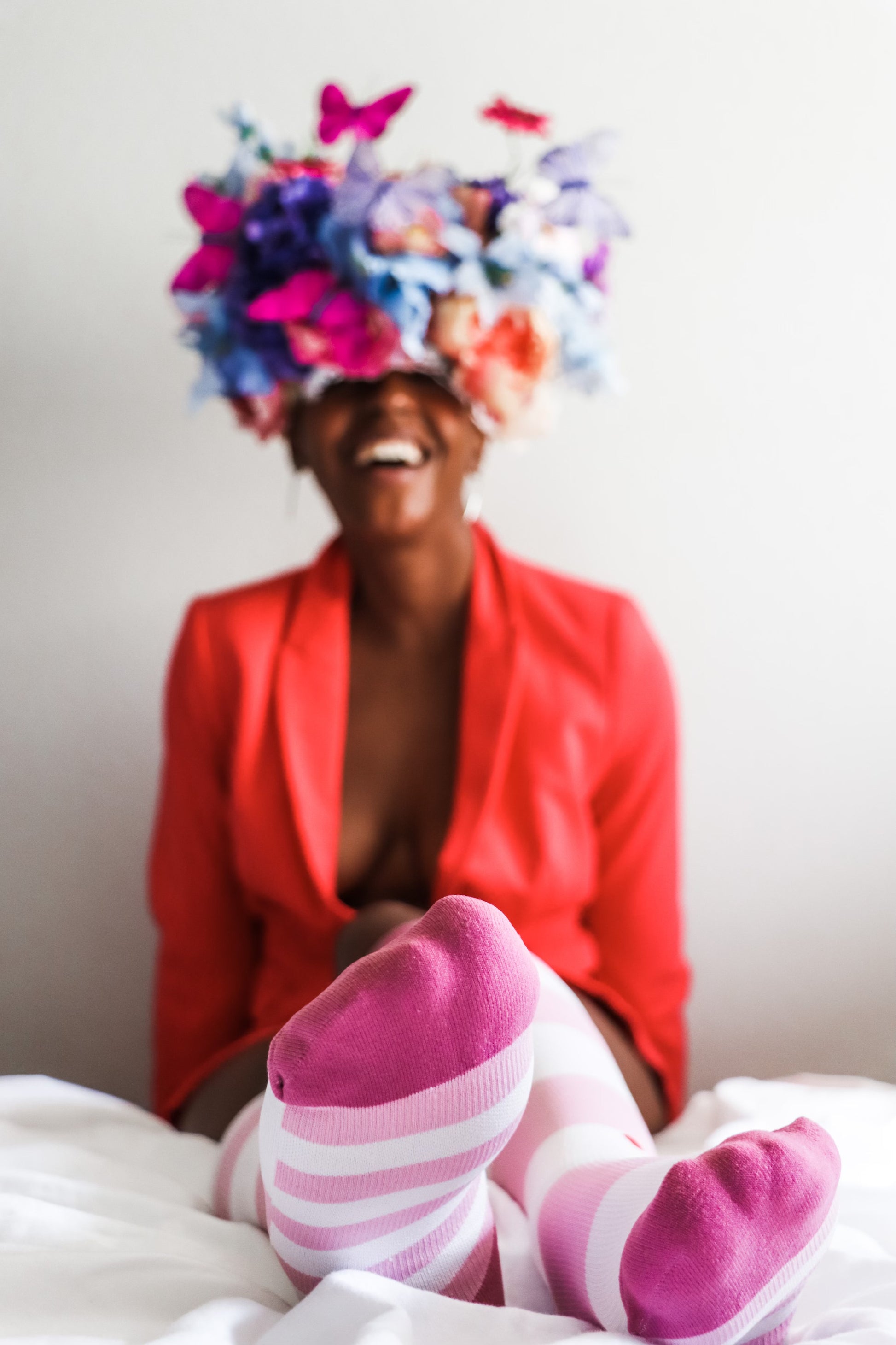 compression socks in varied shades of pink on a beautiful black woman in a floral crown