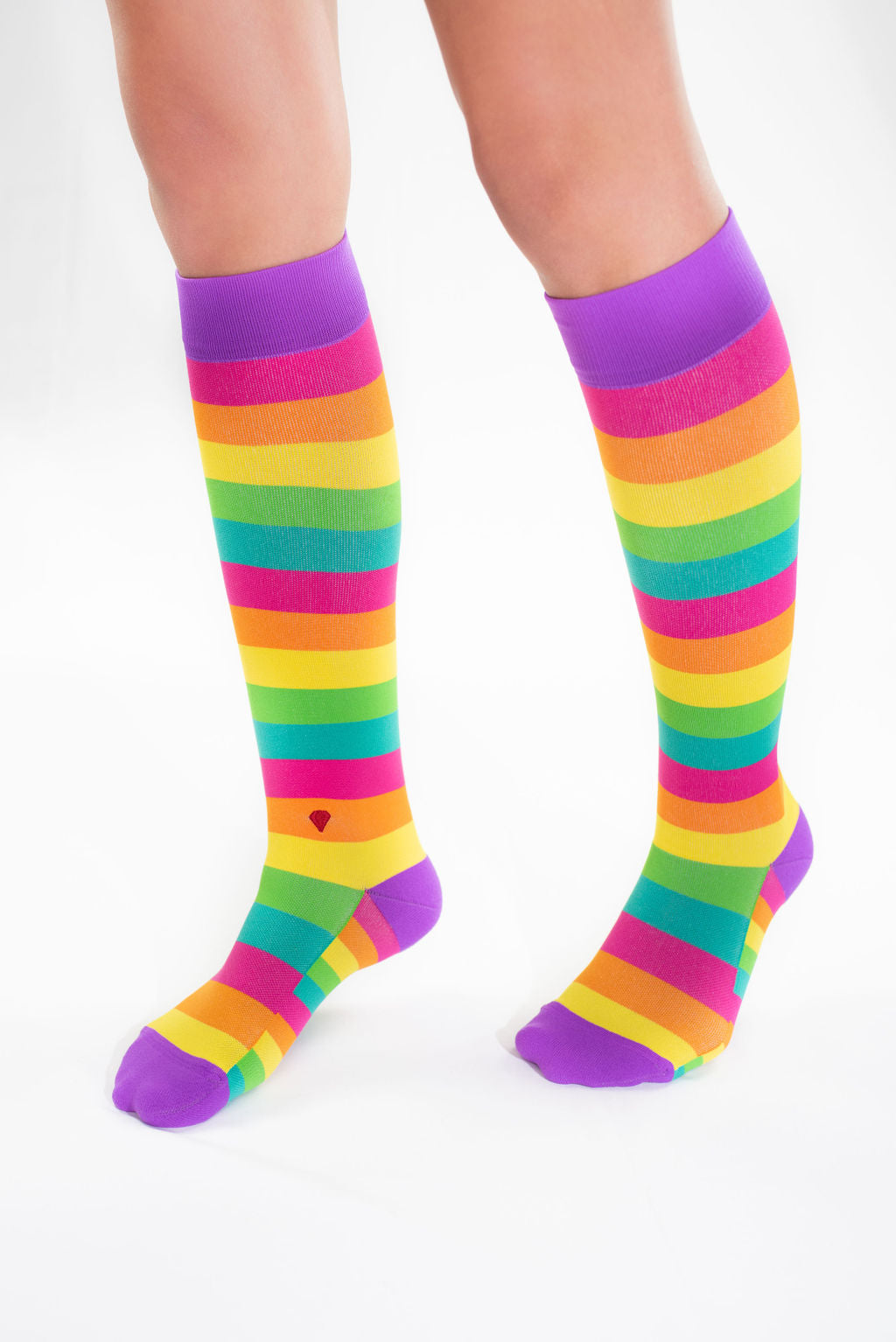 compression socks with rainbow stripes in pink, orange, yellow, green, and teal with purple accents