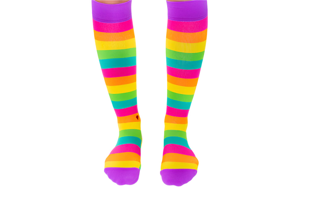 compression socks with rainbow stripes in pink, orange, yellow, green, and teal with purple accents