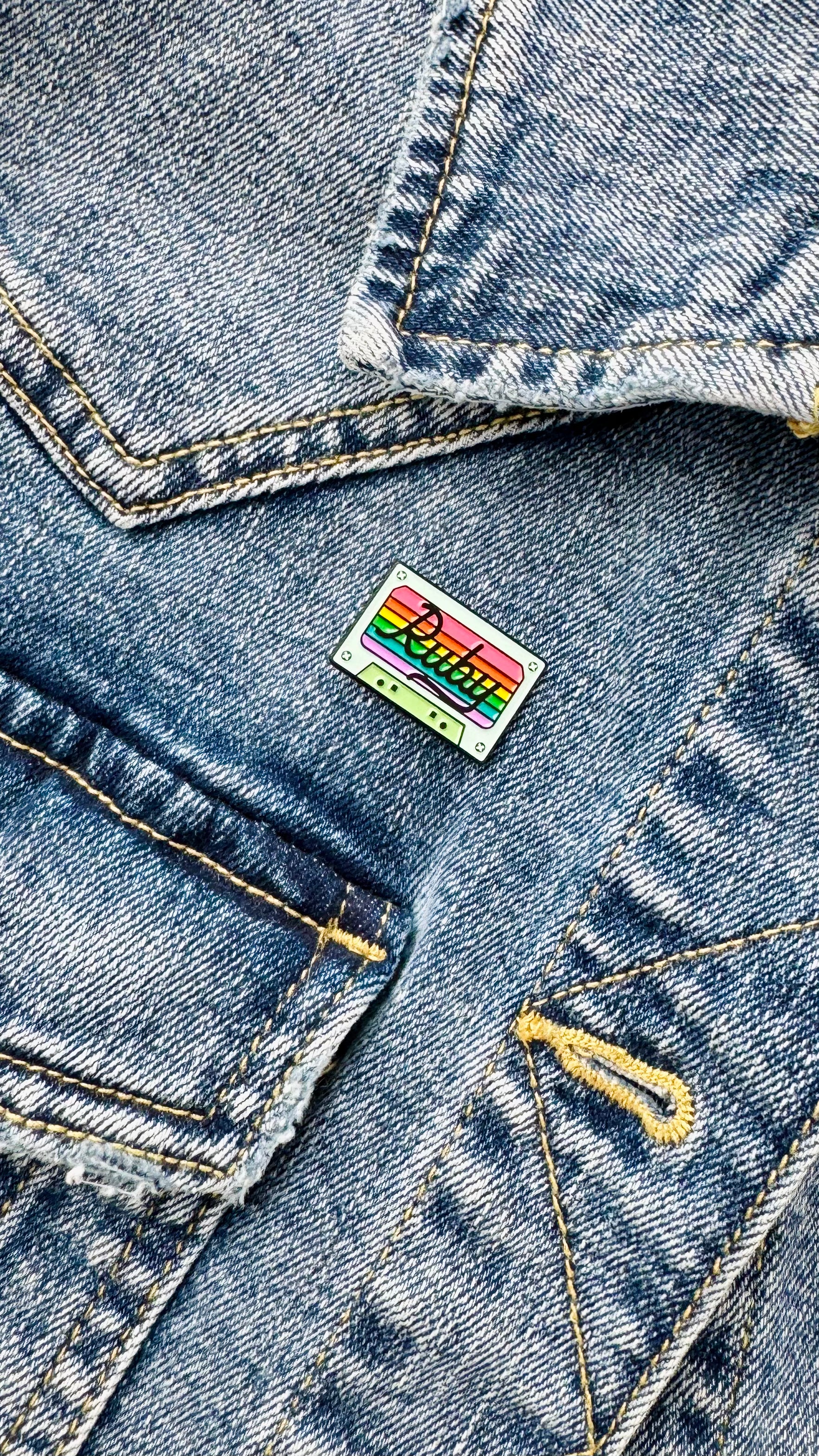 Ruby's cassette tape pin on a blue denim jean jacket
